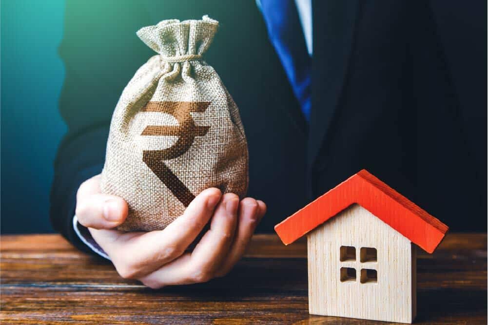 Money and house symbolizing home loan or property funding