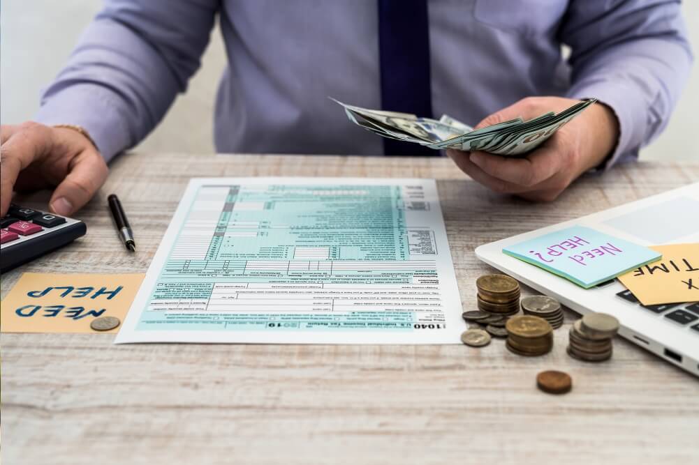 Financial consultant reviewing tax forms and cash flow