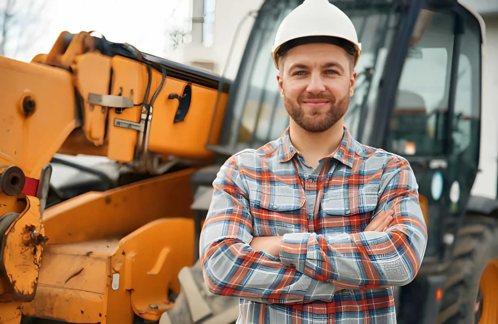 In white hard hat Man is with tractor