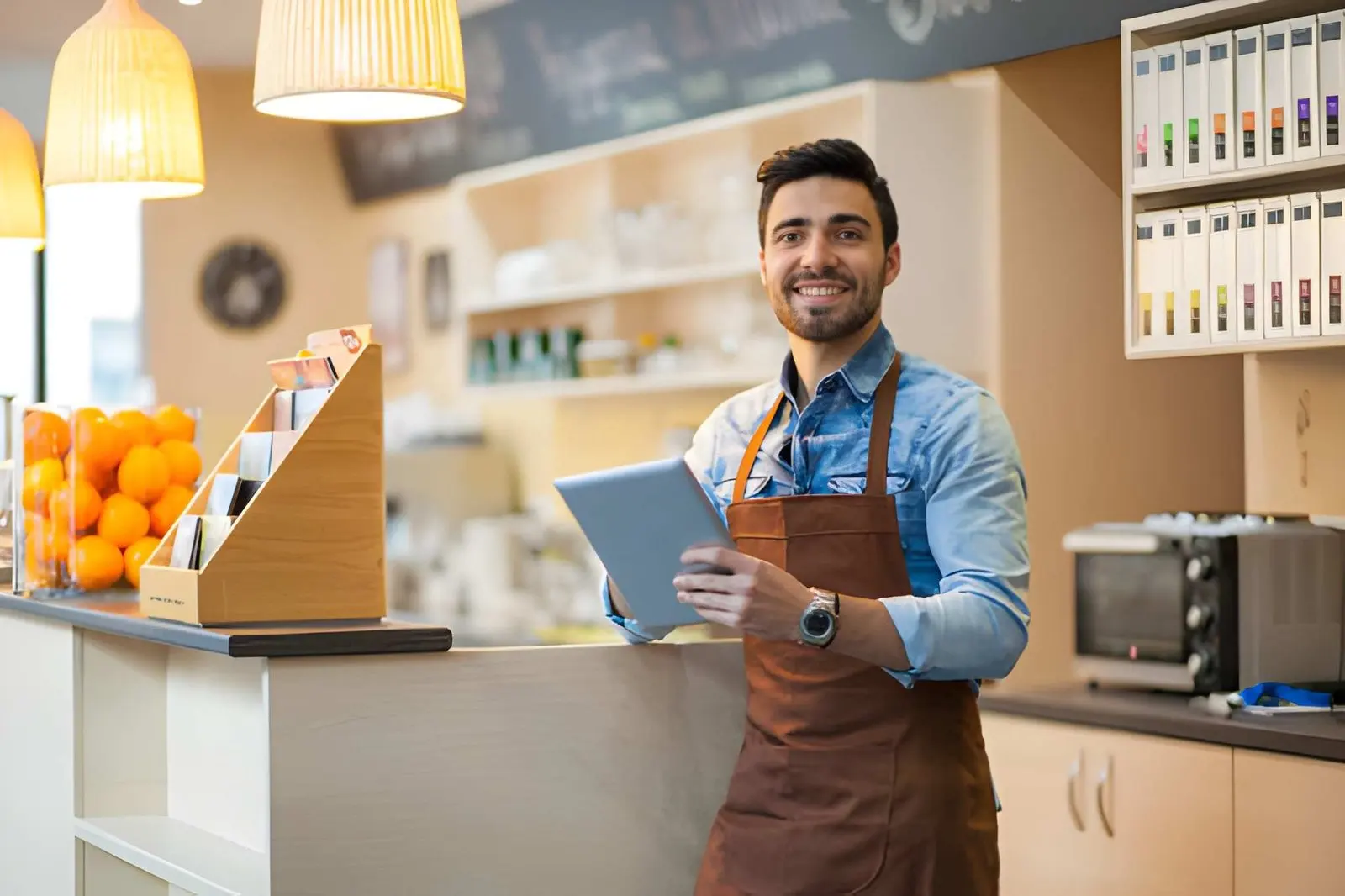 Young bar owner with digital tablet